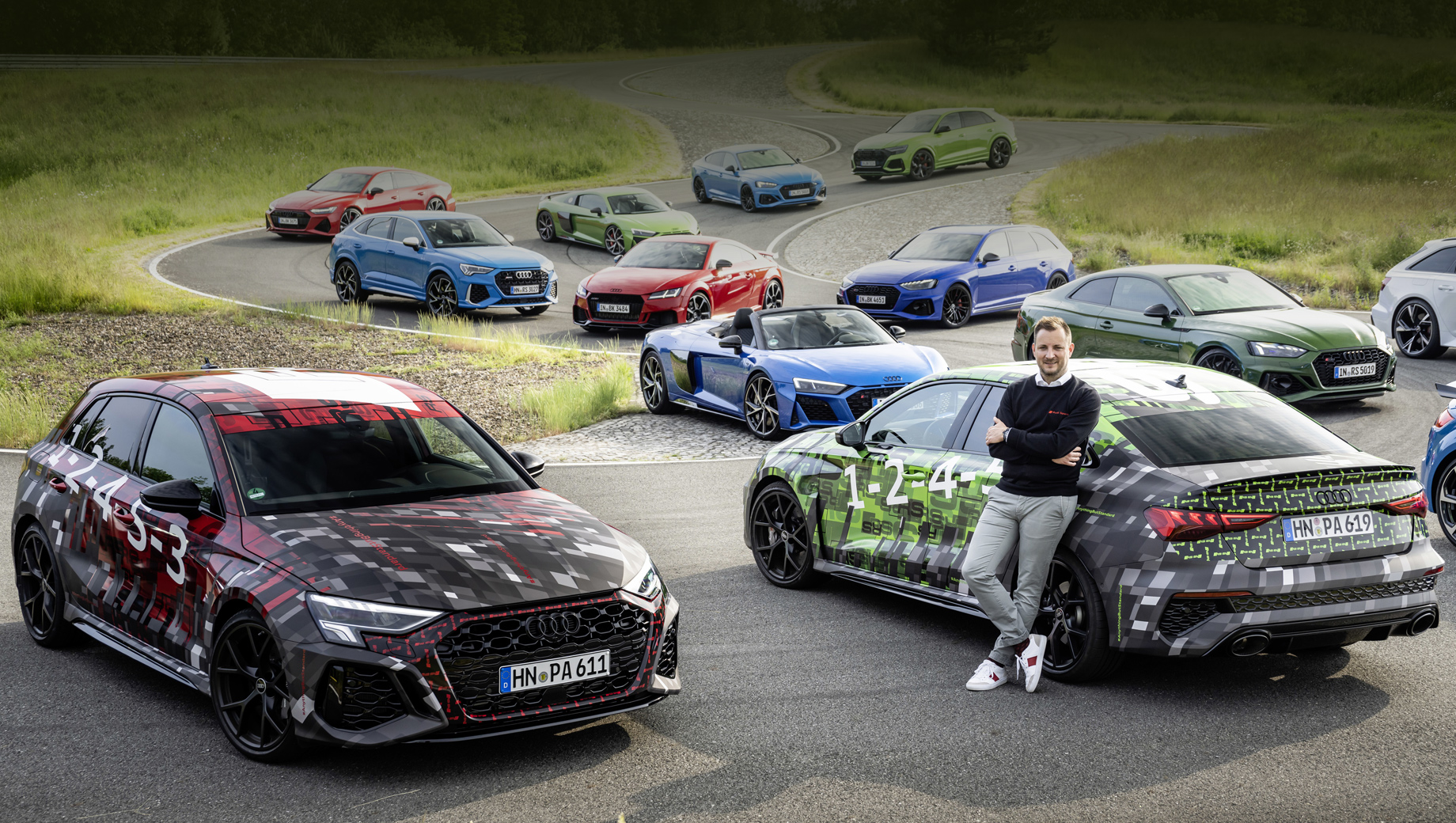 Audi rs3,Audi rs3 sportback. Около грядущих новинок позирует новый управляющий директор Audi Sport Себастьян Грамс. На заднем плане — другие модели отделения.